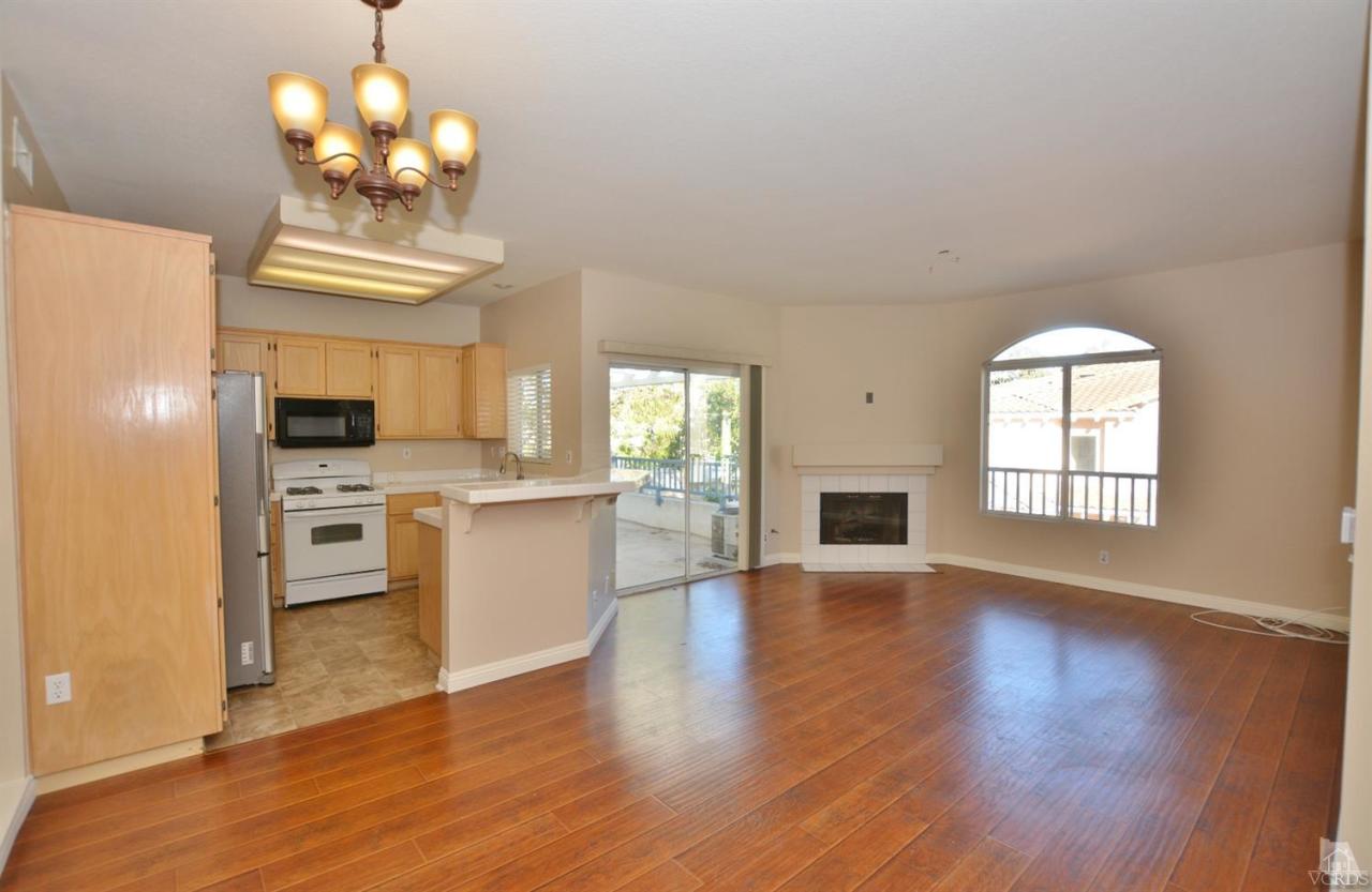 11621 Countrysprings Court, Unit 16 Moorpark, CA 93021 - Photo 2 of 14 a view of a kitchen with wooden floor and stainless steel appliances