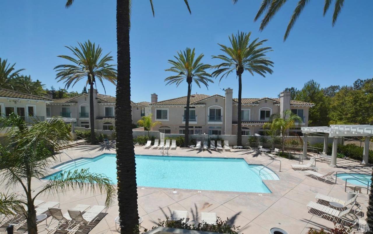 11621 Countrysprings Court, Unit 16 Moorpark, CA 93021 - Photo 13 of 14 a view of a swimming pool with a chair and tables