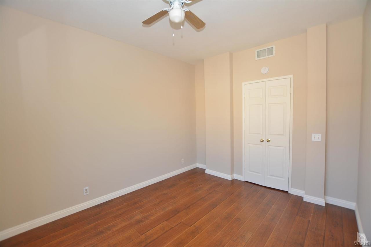11621 Countrysprings Court, Unit 16 Moorpark, CA 93021 - Photo 4 of 14 a view of an empty room with wooden floor