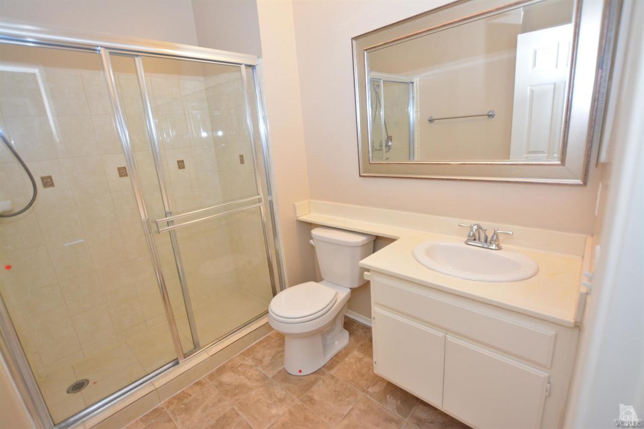 11621 Countrysprings Court, Unit 16 Moorpark, CA 93021 - Photo 5 of 14 a bathroom with a sink a toilet and a mirror