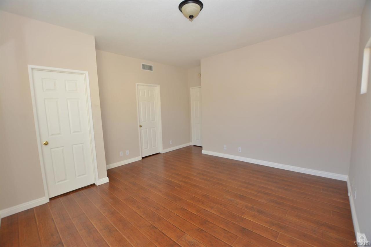 11621 Countrysprings Court, Unit 16 Moorpark, CA 93021 - Photo 6 of 14 a view of an empty room with wooden floor