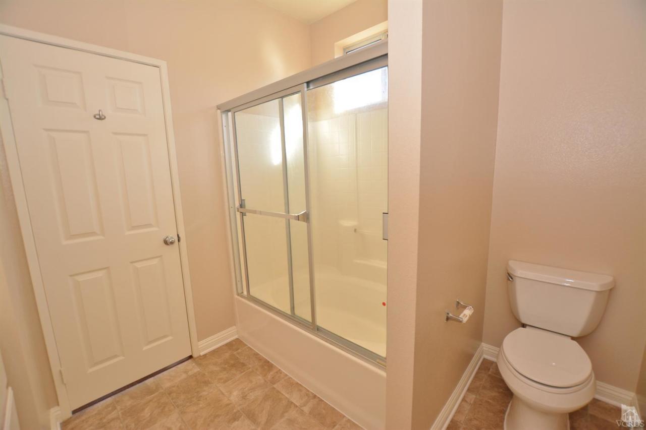 11621 Countrysprings Court, Unit 16 Moorpark, CA 93021 - Photo 7 of 14 a bathroom with a toilet and a shower