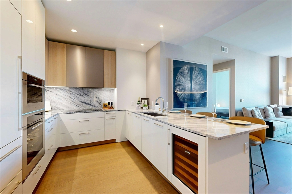a kitchen with a sink stove and cabinets