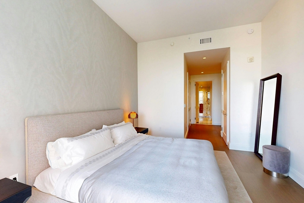 240 Devonshire Street, Unit 4210 Boston, MA 02110 - Photo 5 of 39 a bedroom with a bed and a mirror