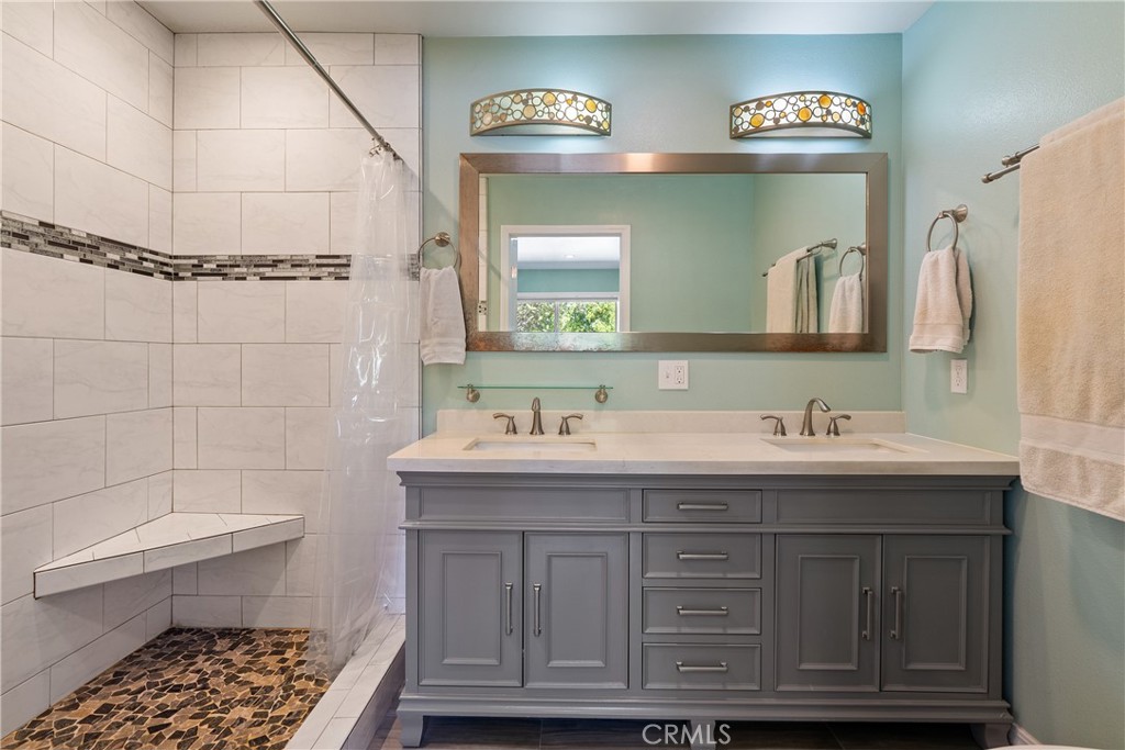 3388 Ramona Road Atascadero, CA 93422 - Photo 31 of 55 The ensuite bathroom boasts a dual sink, marble top vanity and tiled floors.