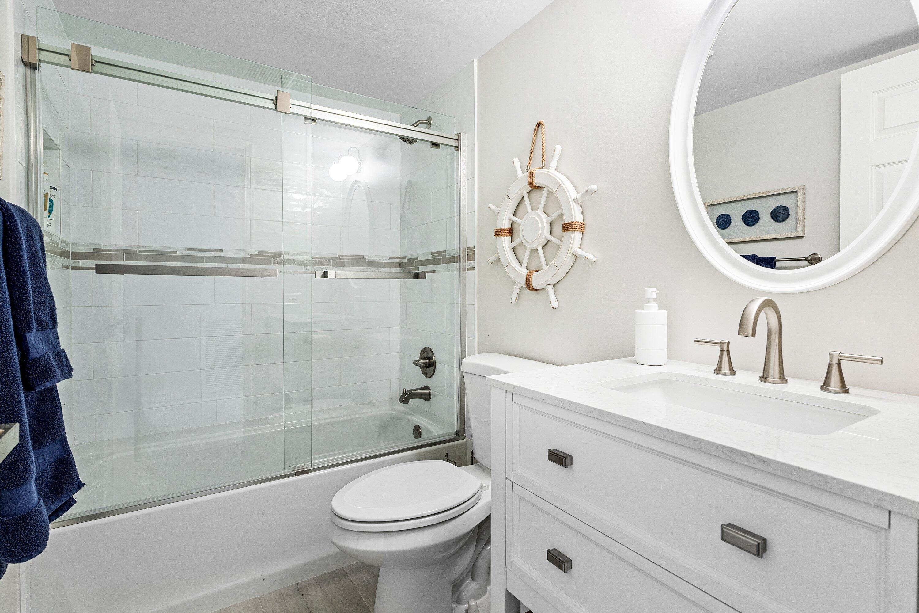 7918 Granada Place, Unit 103 Boca Raton, FL 33433 - Photo 20 of 31 a bathroom with a sink a toilet and a mirror