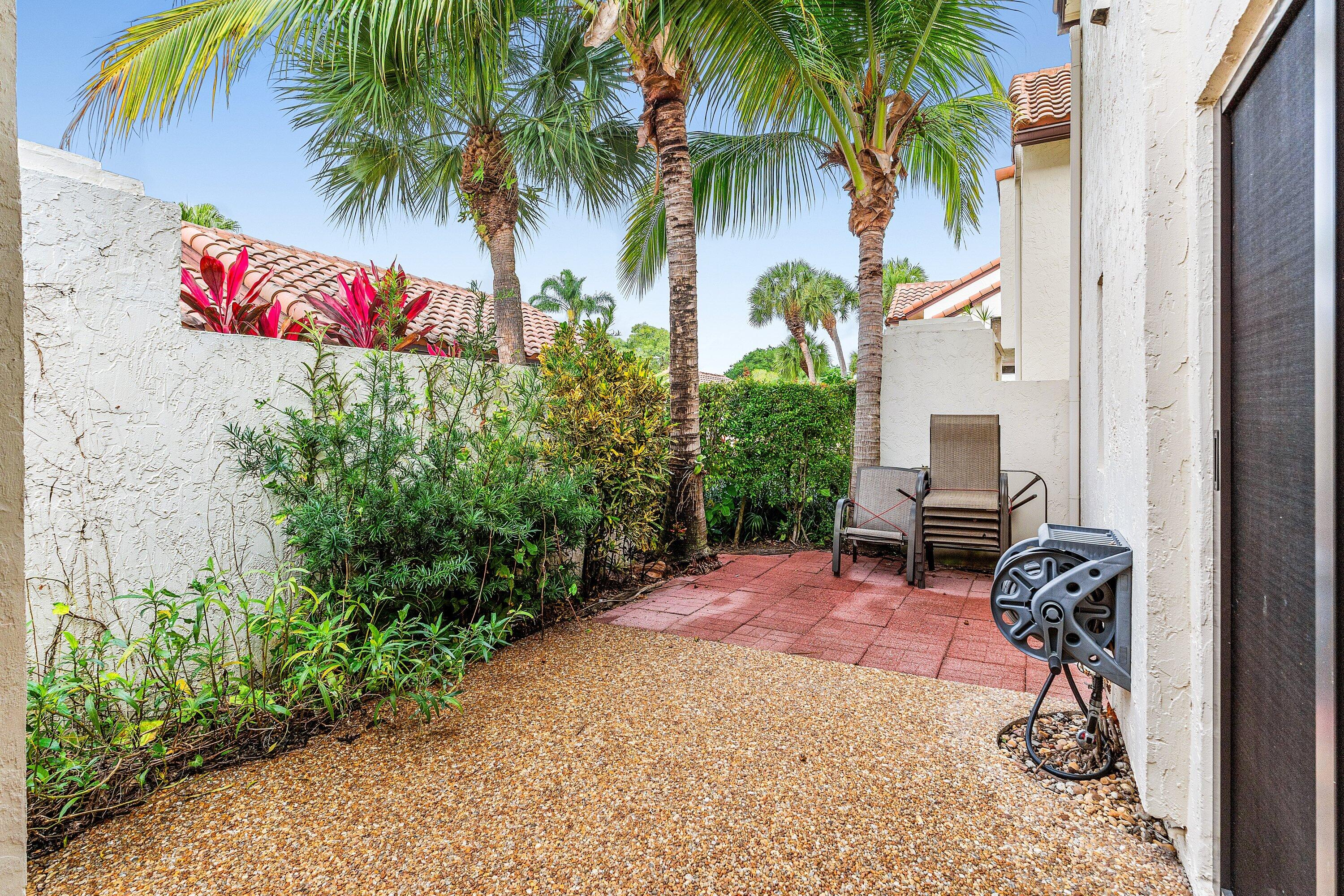 7918 Granada Place, Unit 103 Boca Raton, FL 33433 - Photo 28 of 31 a view of a backyard with a sitting area
