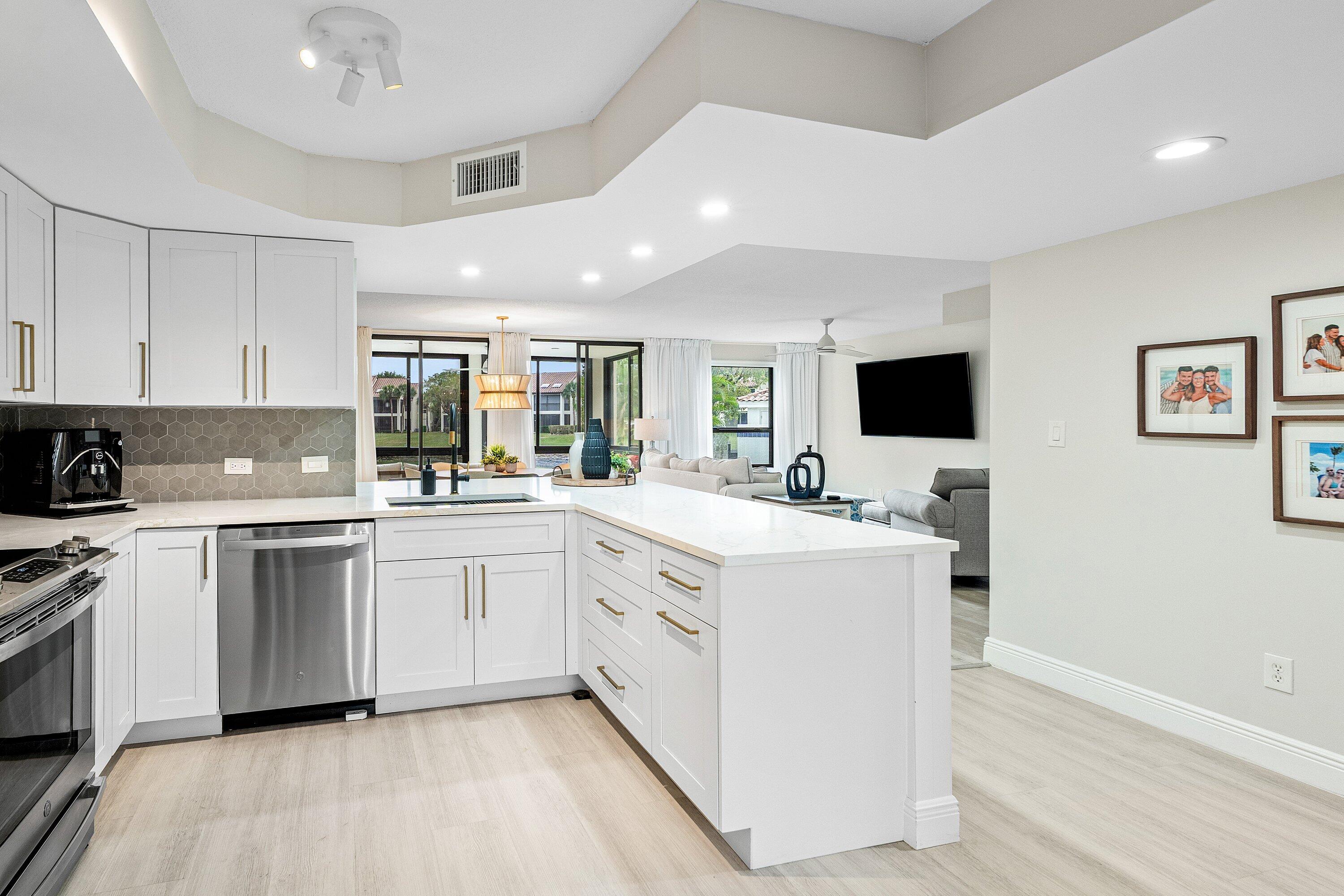 7918 Granada Place, Unit 103 Boca Raton, FL 33433 - Photo 5 of 31 a kitchen with a sink microwave and cabinets
