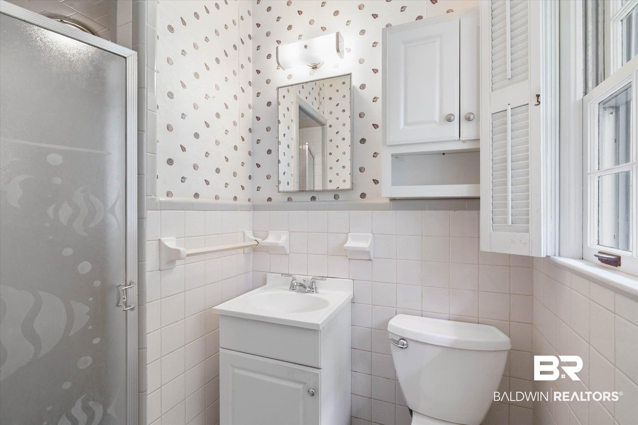 1182 Ginger Drive Mobile, AL 36693 - Photo 20 of 37 Bathroom featuring a glass-enclosed shower, white tile walls, a white vanity with integrated sink, and white wall-mounted cabinetry