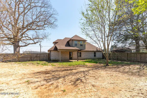 a house that has a tree in front of it