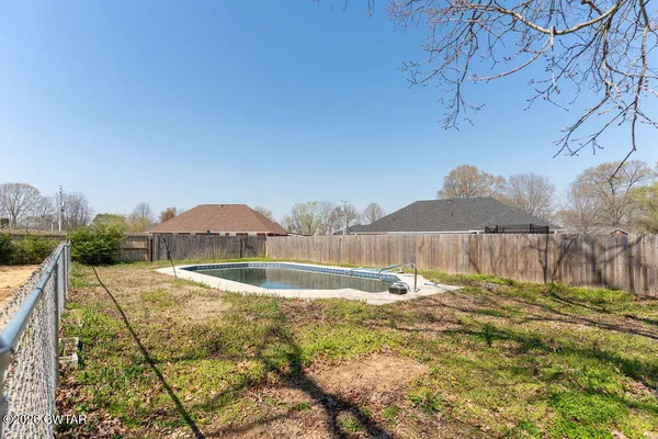 a view of swimming pool with a yard