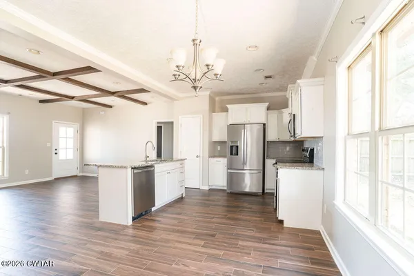 a kitchen with stainless steel appliances a stove top oven and a window
