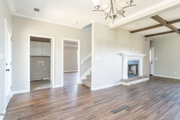 wooden floor chandelier and windows in a room