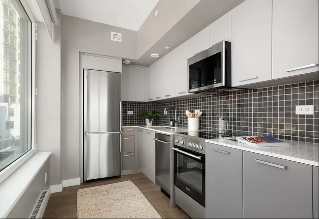 a kitchen with a stove microwave and refrigerator