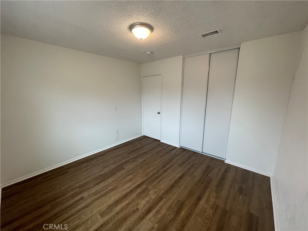 25141 Silent Creek Road Moreno Valley, CA 92553 - Photo 18 of 40 a view of room with wooden floor
