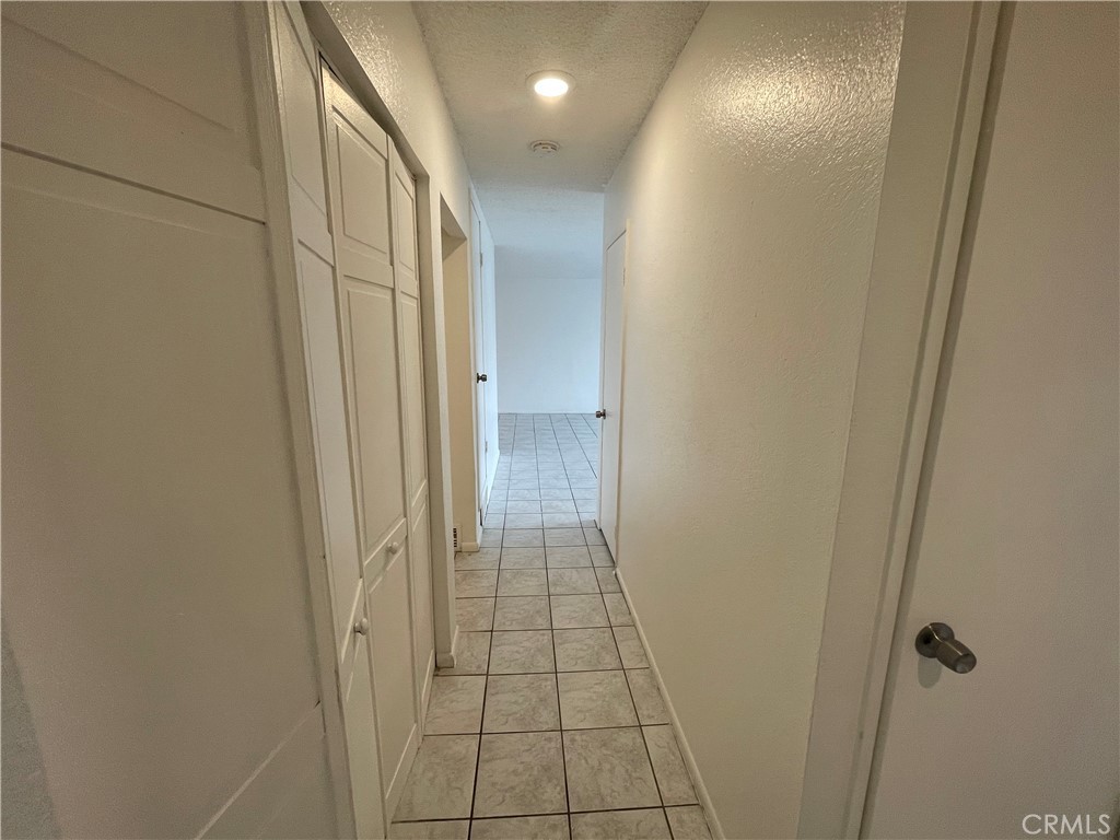 25141 Silent Creek Road Moreno Valley, CA 92553 - Photo 21 of 40 a view of hallway with a bathroom