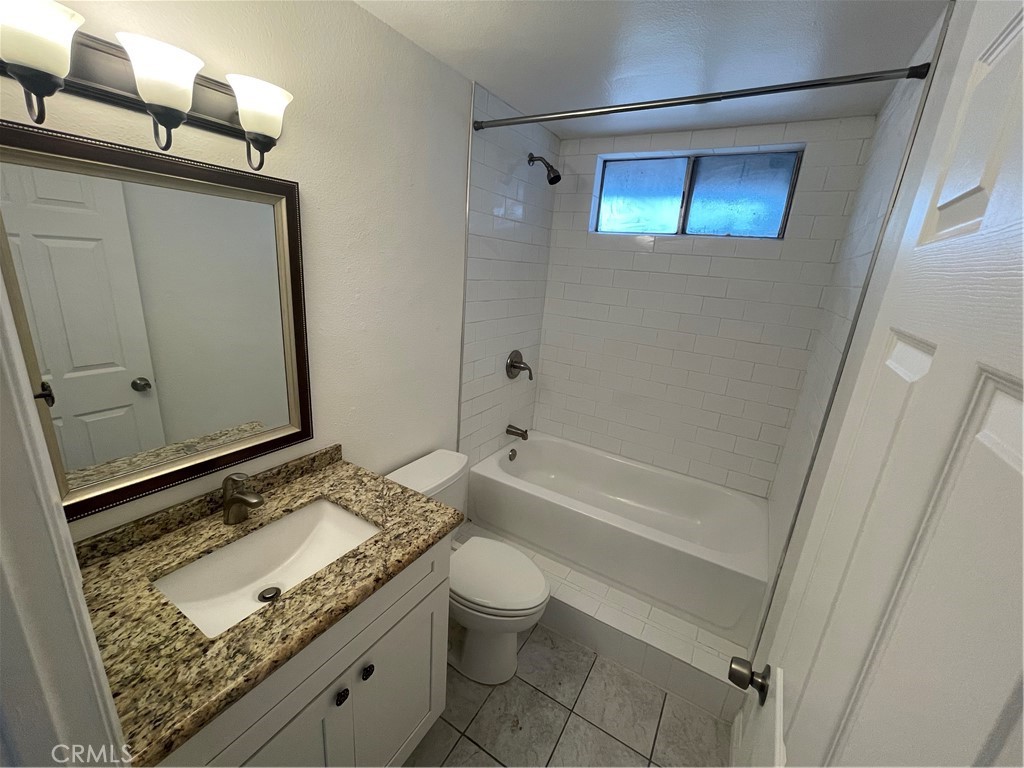 25141 Silent Creek Road Moreno Valley, CA 92553 - Photo 24 of 40 a bathroom with a granite countertop sink toilet and shower