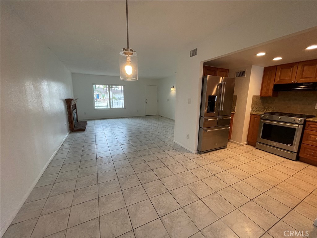 25141 Silent Creek Road Moreno Valley, CA 92553 - Photo 3 of 40 an empty room with fireplace and windows