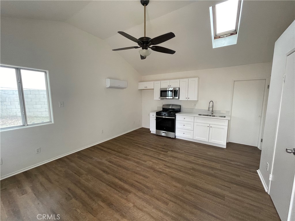 25141 Silent Creek Road Moreno Valley, CA 92553 - Photo 33 of 40 a view of a kitchen with microwave and cabinets