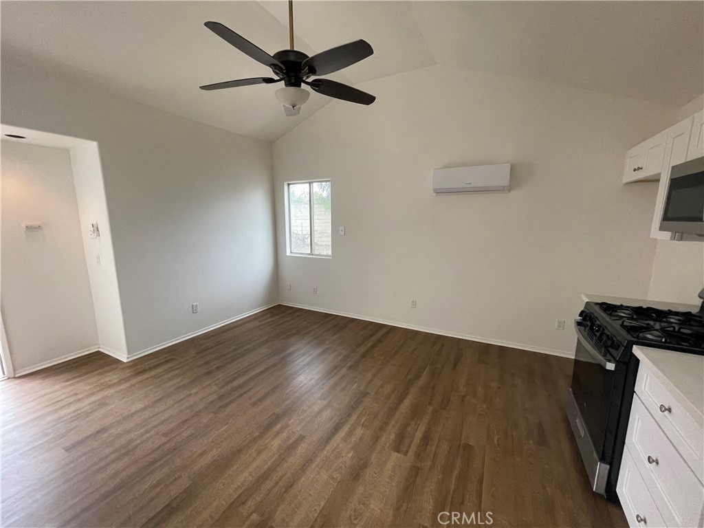 25141 Silent Creek Road Moreno Valley, CA 92553 - Photo 34 of 40 a view of a livingroom with wooden floor and a ceiling fan
