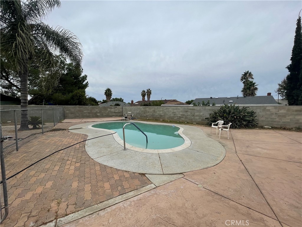 25141 Silent Creek Road Moreno Valley, CA 92553 - Photo 35 of 40 a view of a swimming pool with a yard
