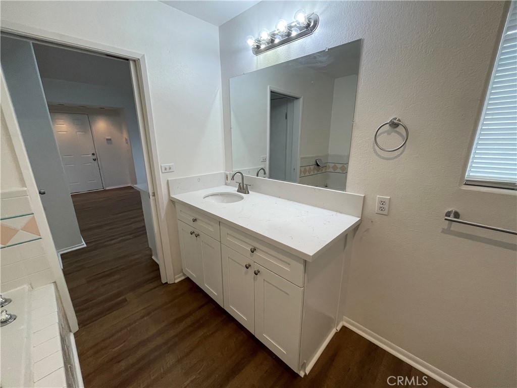 25141 Silent Creek Road Moreno Valley, CA 92553 - Photo 39 of 40 a spacious bathroom with a sink and a mirror