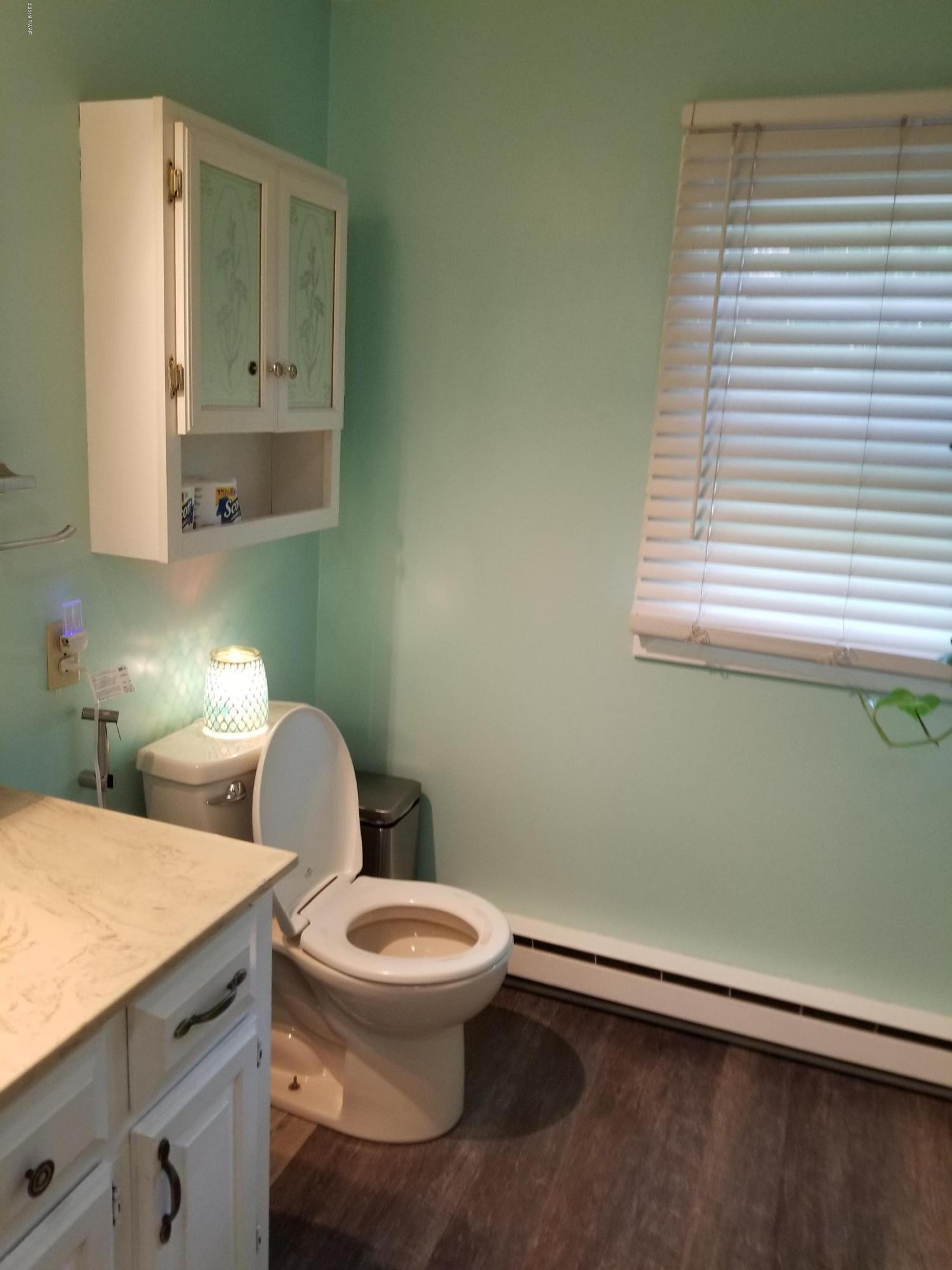 144 Mid Valley Road Lake Ariel, PA 18436 - Photo 30 of 55 a white toilet sitting next to a bathroom sink