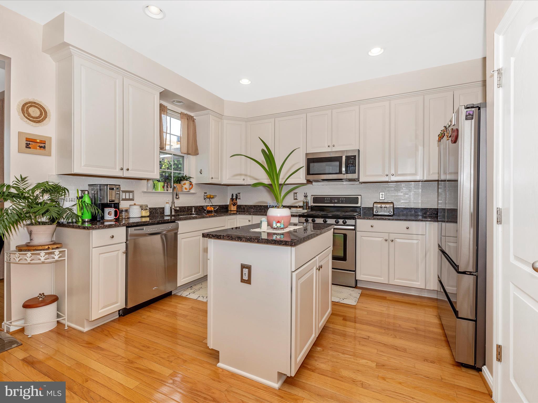 12954 Yellow Jacket Road Hagerstown, MD 21740 - Photo 15 of 54 a kitchen with white cabinets stainless steel appliances a sink and a potted plant