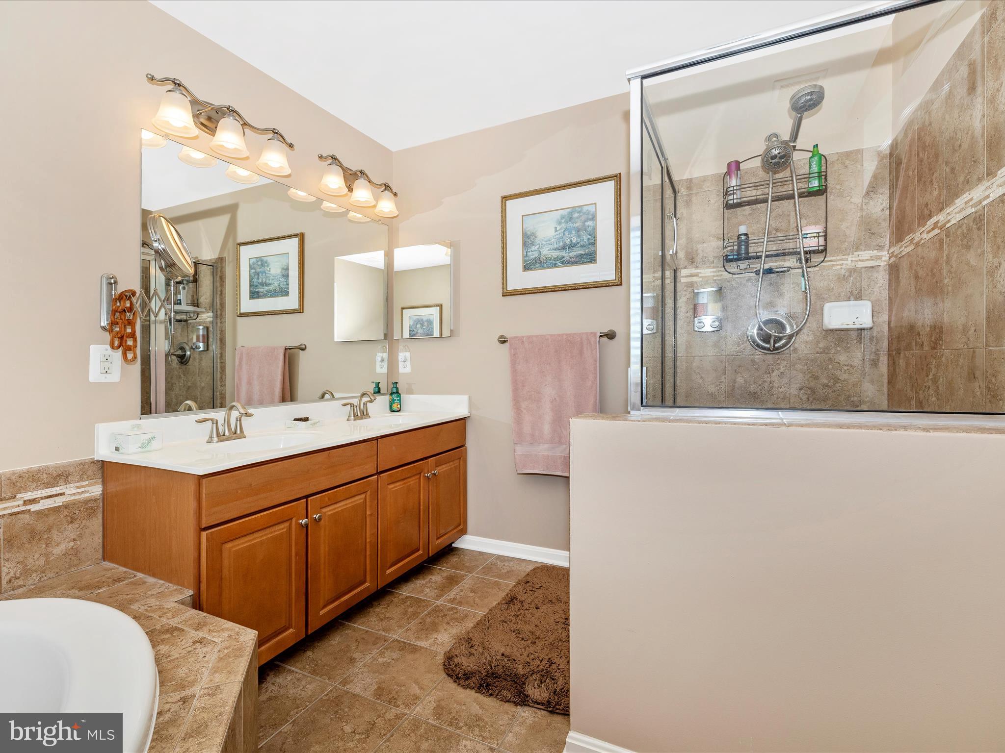 12954 Yellow Jacket Road Hagerstown, MD 21740 - Photo 34 of 54 a spacious bathroom with a double vanity sink mirror and bathtub