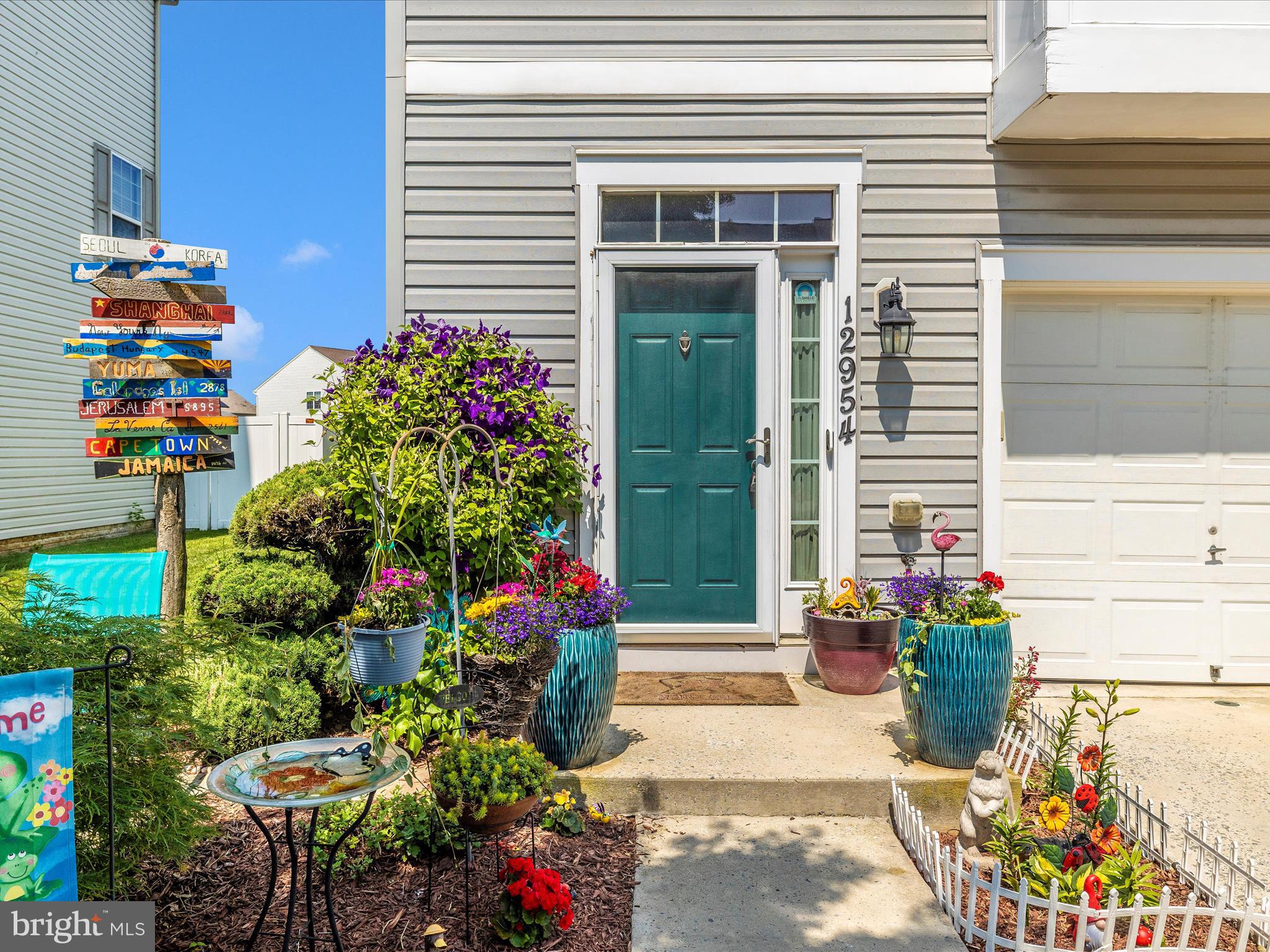 12954 Yellow Jacket Road Hagerstown, MD 21740 - Photo 4 of 54 a front view of a house with a yard and flowers