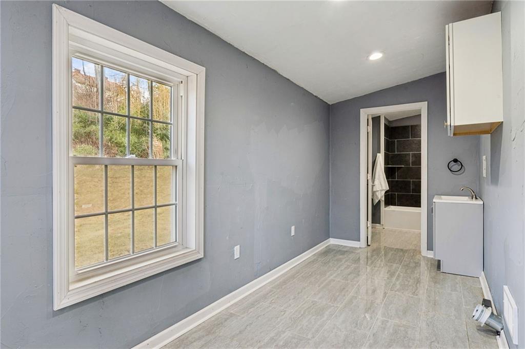 148 Sycamore Street Irwin, PA 15642 - Photo 14 of 45 an empty room with wooden floor and windows