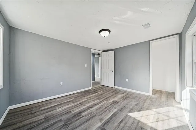 a view of an empty room with wooden floor