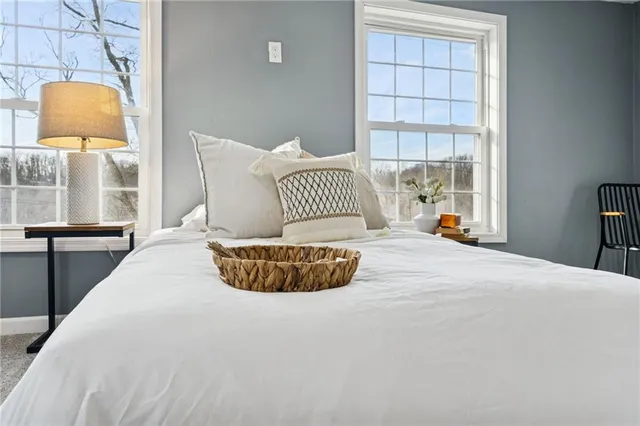 a spacious bedroom with a bed and a window