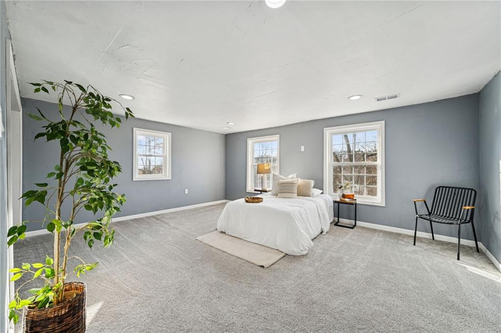 148 Sycamore Street Irwin, PA 15642 - Photo 21 of 45 a spacious bedroom with a bed and a window