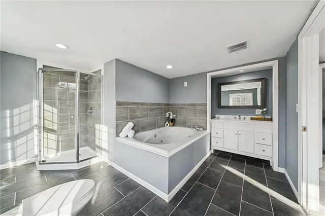 a white bath tub sitting in a bathroom next to a window
