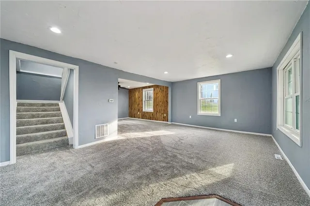 an empty room with windows and closet