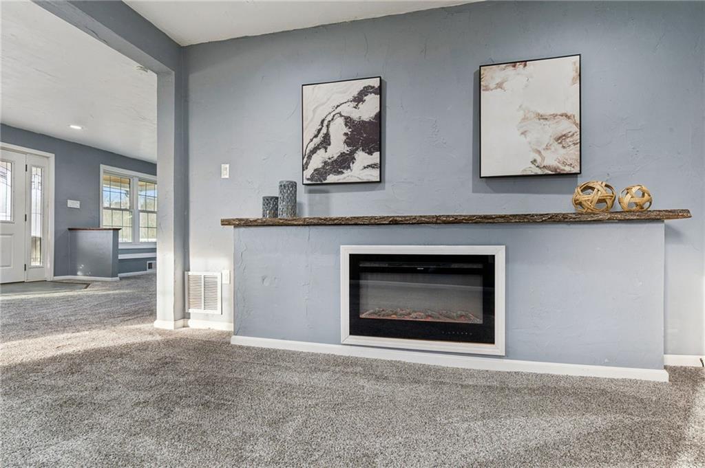 148 Sycamore Street Irwin, PA 15642 - Photo 5 of 45 an empty room with a fireplace and cabinet