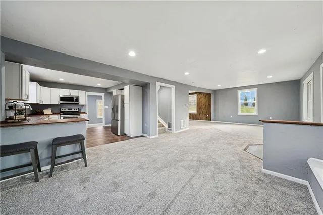 a view of kitchen with furniture and windows