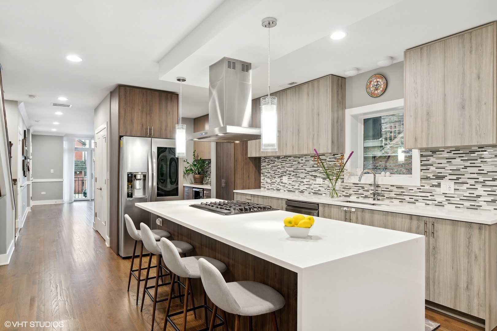1044 West Polk Street, Unit 1 Chicago, IL 60607 - Photo 5 of 22 a kitchen with stainless steel appliances granite countertop a sink a stove a refrigerator and island with wooden floor