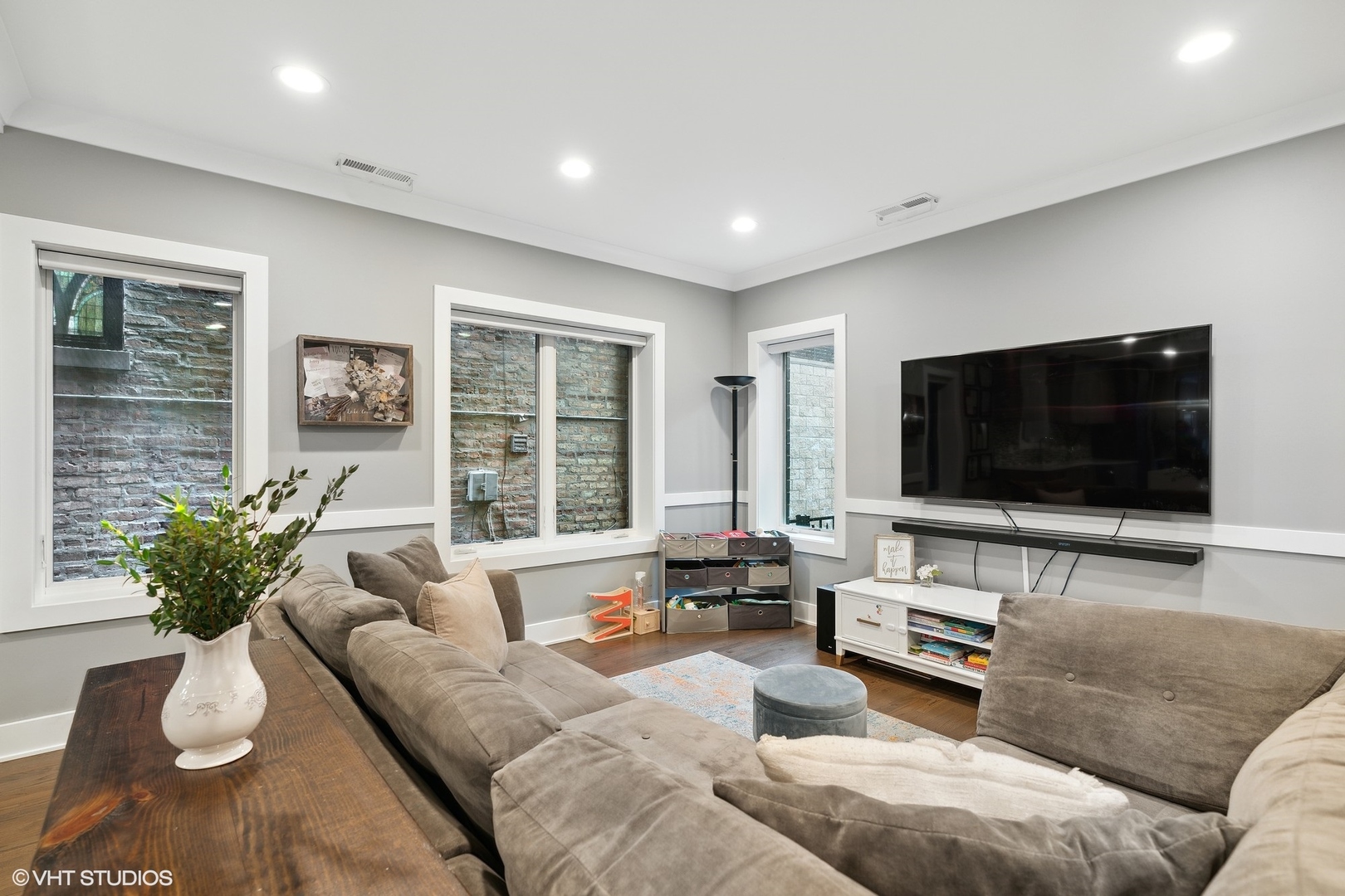 1044 West Polk Street, Unit 1 Chicago, IL 60607 - Photo 8 of 22 a living room with furniture and a flat screen tv