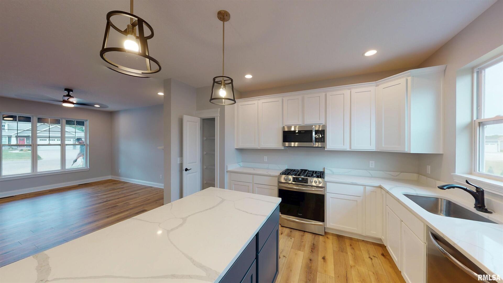 11 Faiths Way Bettendorf, IA 52722 - Photo 15 of 22 a kitchen that has a lot of cabinets and wooden floor