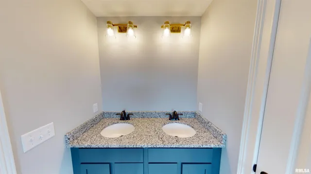 a bathroom with a granite countertop sink and mirror