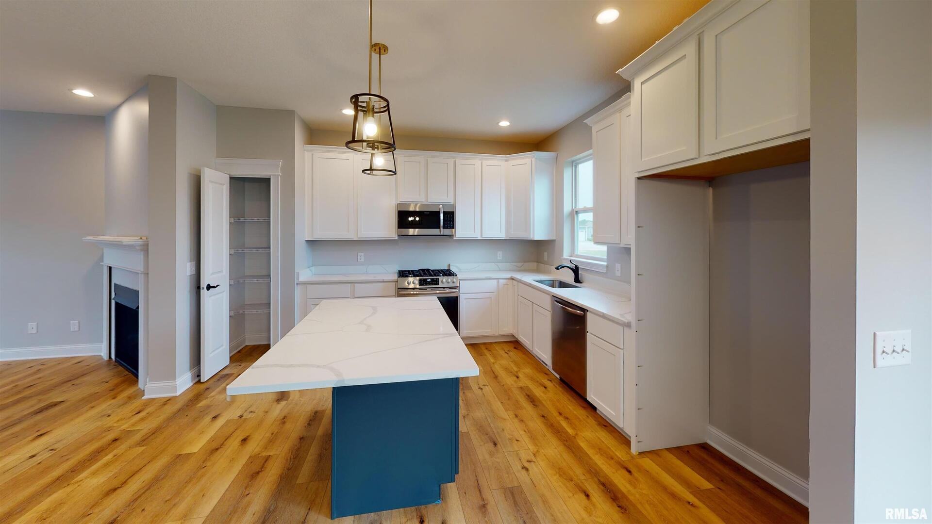 11 Faiths Way Bettendorf, IA 52722 - Photo 4 of 22 a kitchen with stainless steel appliances granite countertop a refrigerator a sink dishwasher a stove and white cabinets with wooden floor