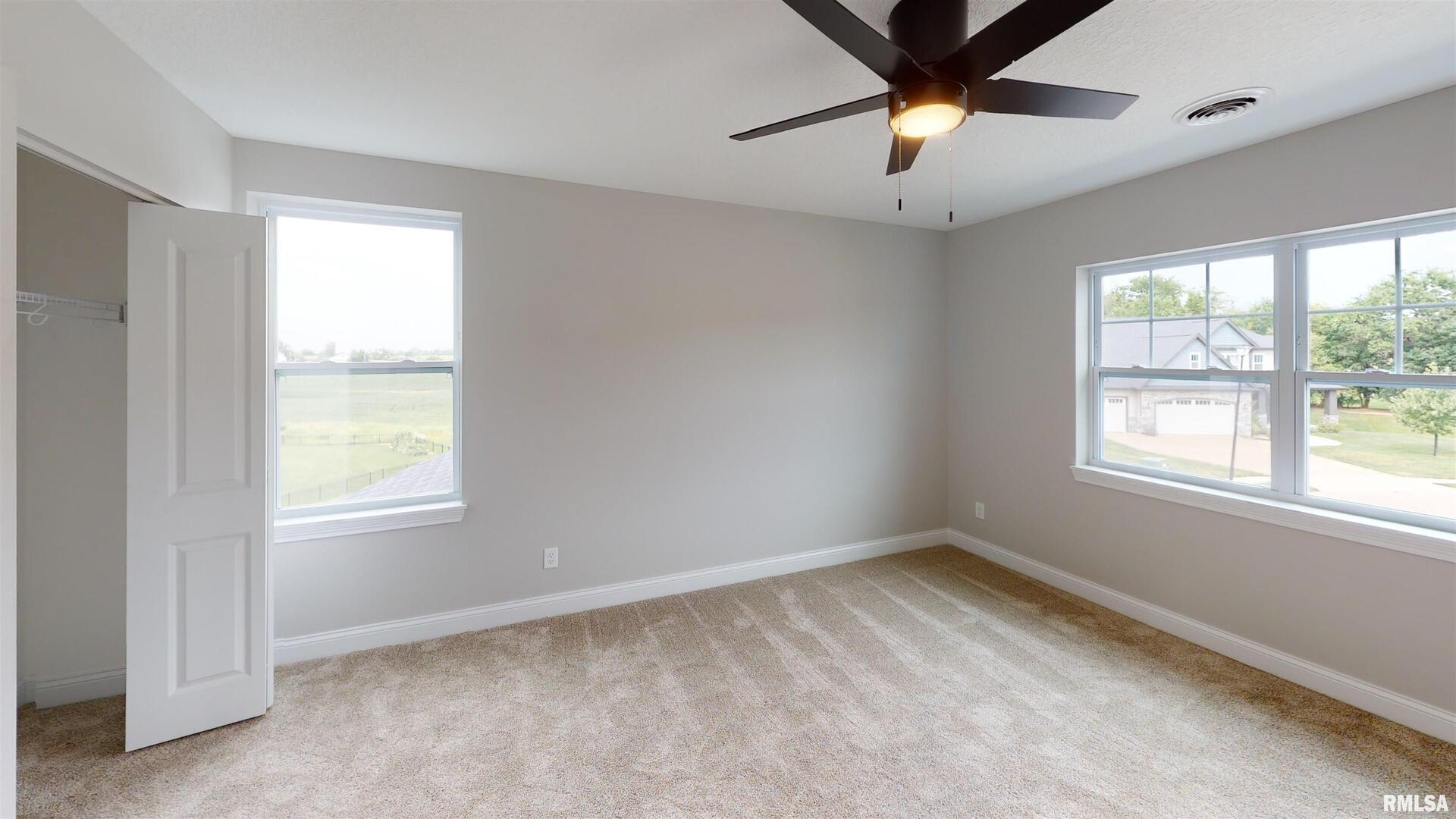 11 Faiths Way Bettendorf, IA 52722 - Photo 6 of 22 a view of an empty room and window and a chandelier fan