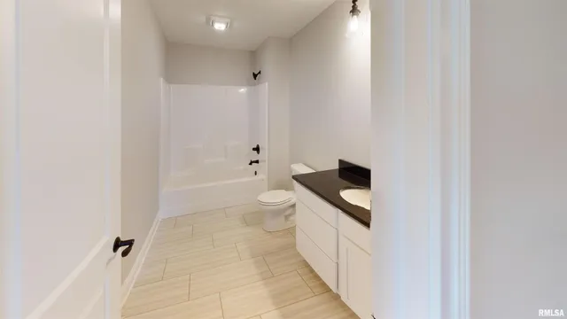 a bathroom with a toilet a sink and bathtub