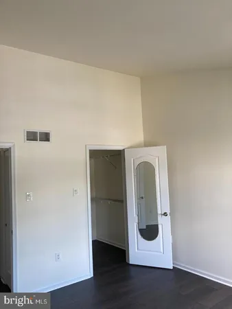a utility room with wooden floor washer and dryer