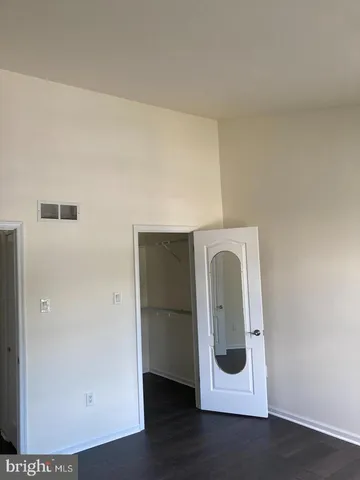 a utility room with wooden floor washer and dryer