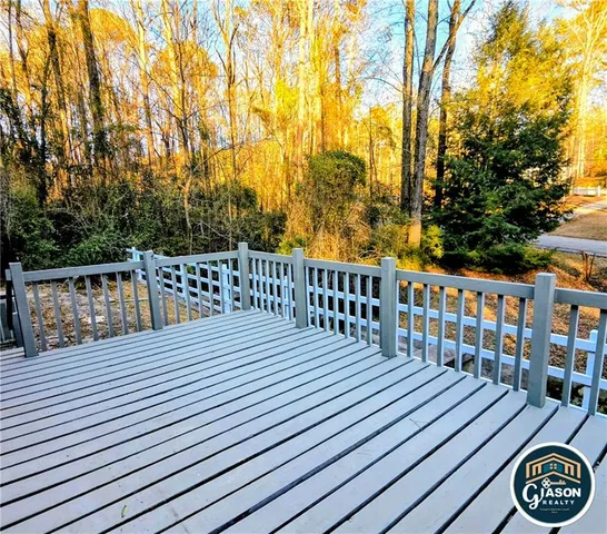 a balcony with wooden floor and fence