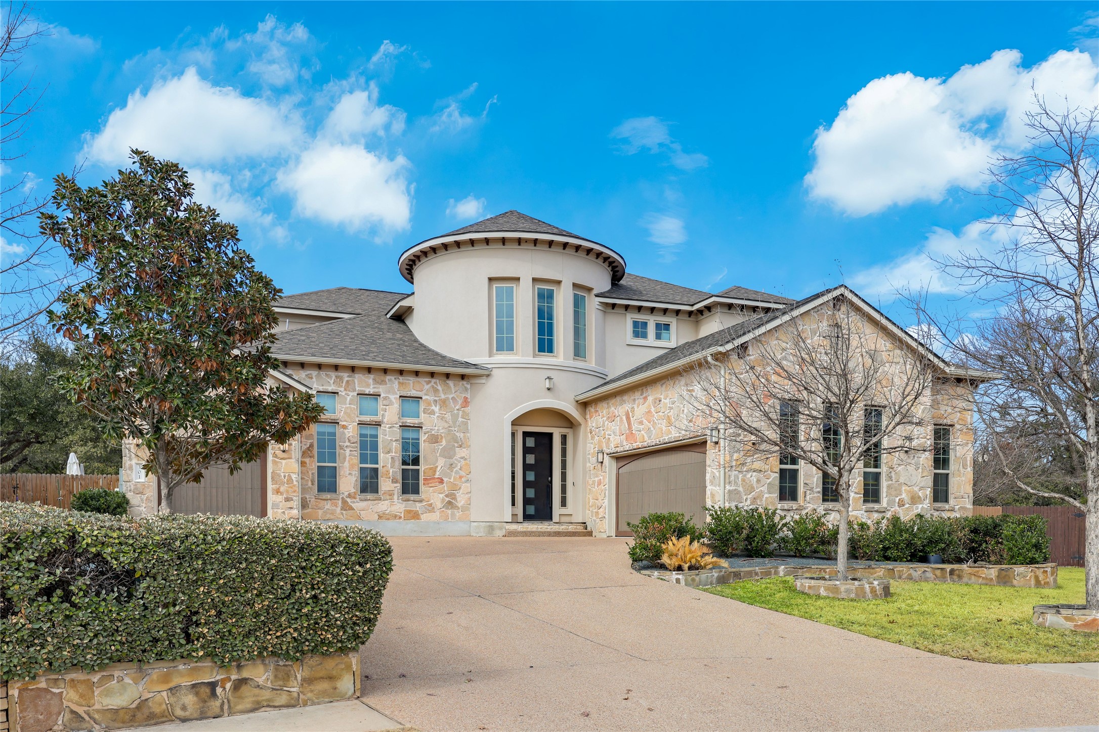 301 Raging River Road Cedar Park, TX 78613 - Photo 1 of 1 Mediterranean / spanish-style home with stone siding, concrete driveway, roof with shingles, stucco siding, and a garage