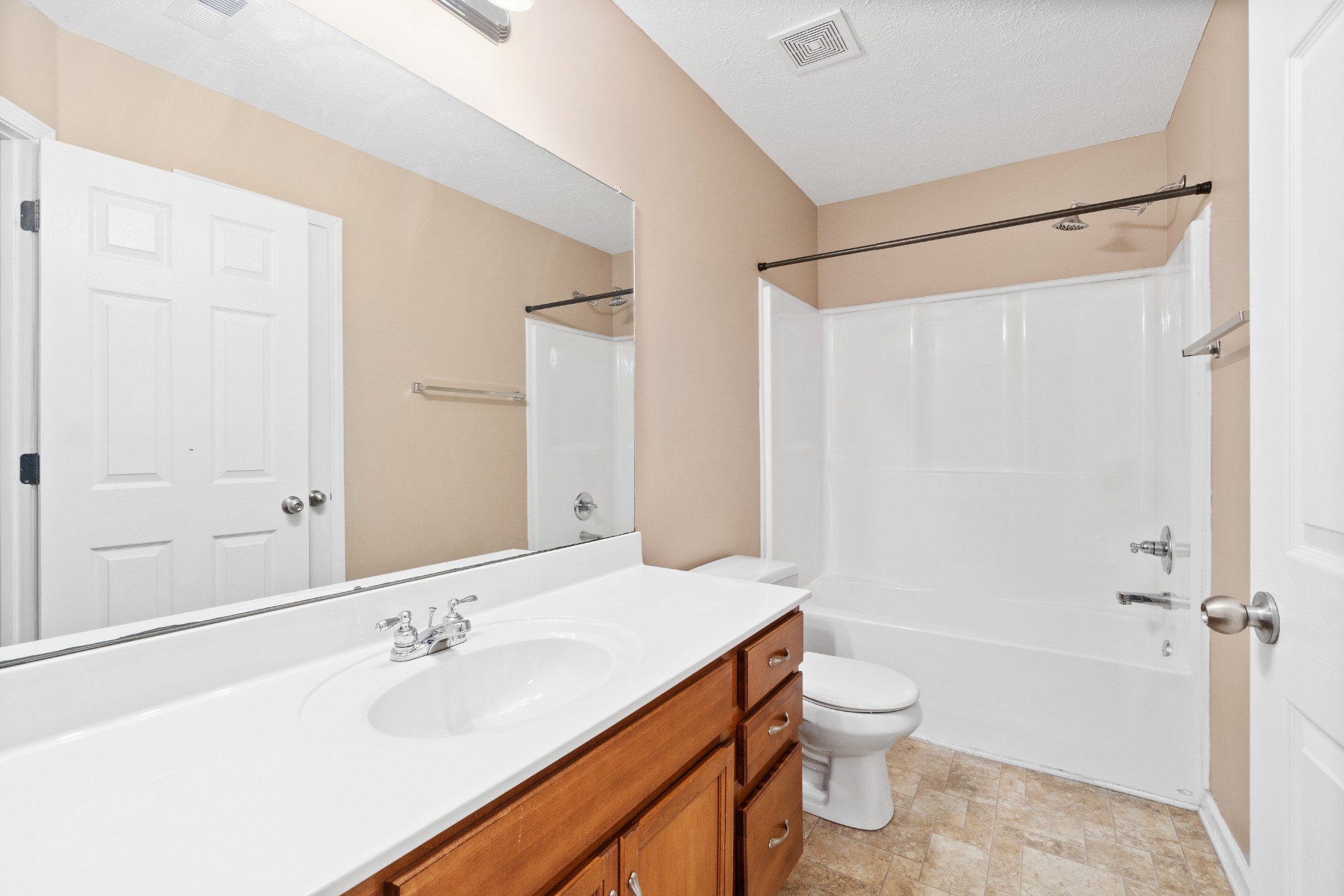 3178 Cross Ridge Drive Clarksville, TN 37040 - Photo 19 of 25 a bathroom with a granite countertop sink toilet a large mirror a shower and a bathtub